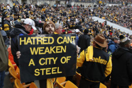 A Pittsburgh Steelers fan holds a sign honoring the victims of a deadly shooting spree at a synagogue on Saturday during the second half of an NFL football game between the Pittsburgh Steelers and the Cleveland Browns, Sunday, Oct. 28, 2018, in Pittsburgh. (AP Photo/Gene J. Puskar)