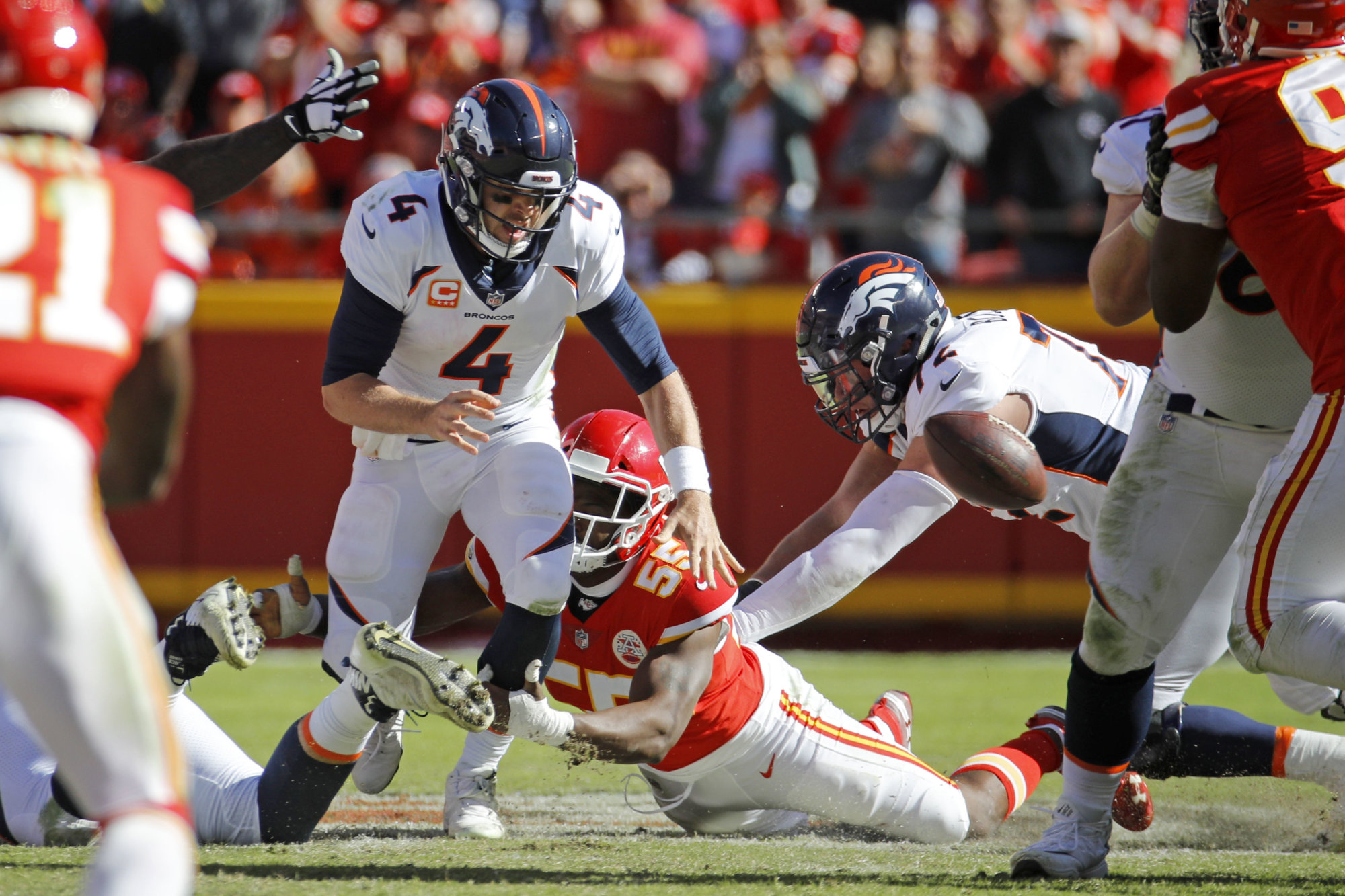 Kansas City Chiefs linebacker Dee Ford (55) sacks Denver Broncos quarterback Case Keenum (4), causing him to fumble the ball for a turnover, during the second half of an NFL football game in Kansas City, Mo., Sunday, Oct. 28, 2018. Linebacker Breeland Speaks (57) recovered the fumble. (AP Photo/Charlie Riedel)