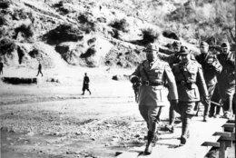 Italian dictator Benito Mussolini walks on an inspection tour of the Albanian Front before the fall of Greece on May 21, 1941 during World War II.  Others in uniform are not identified.  (AP Photo)