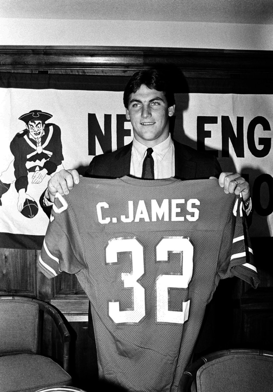 Runningback Craig James holds up his new jersey during a press conference, on Friday, April 20, 1984 at Sullivan Stadium in Foxboro, Mass., where it was announced that he has signed with the New England Patriots football team. James, formerly of the USFL's Washington Federals and Southern Methodist University, was a 7th-round draft pick of the Pastriots in the 1983 NFL Draft. (AP Photo/Ted Qartland)