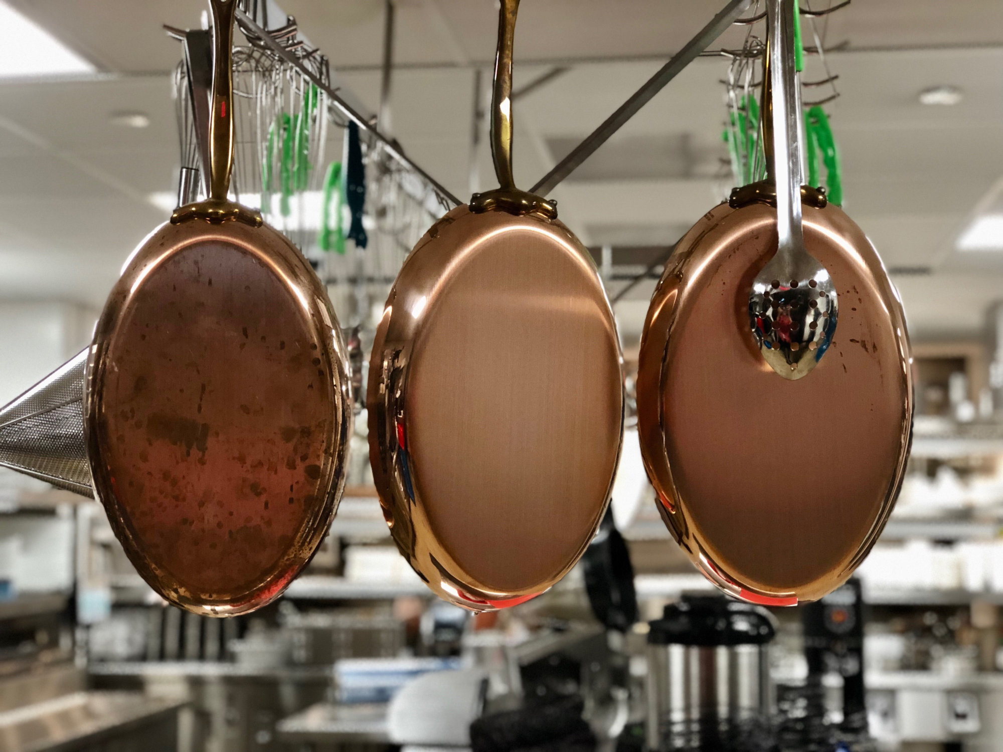 Gleaming copper-bottomed pots in the Annapolis Yacht Club kitchen. (WTOP/Kate Ryan)