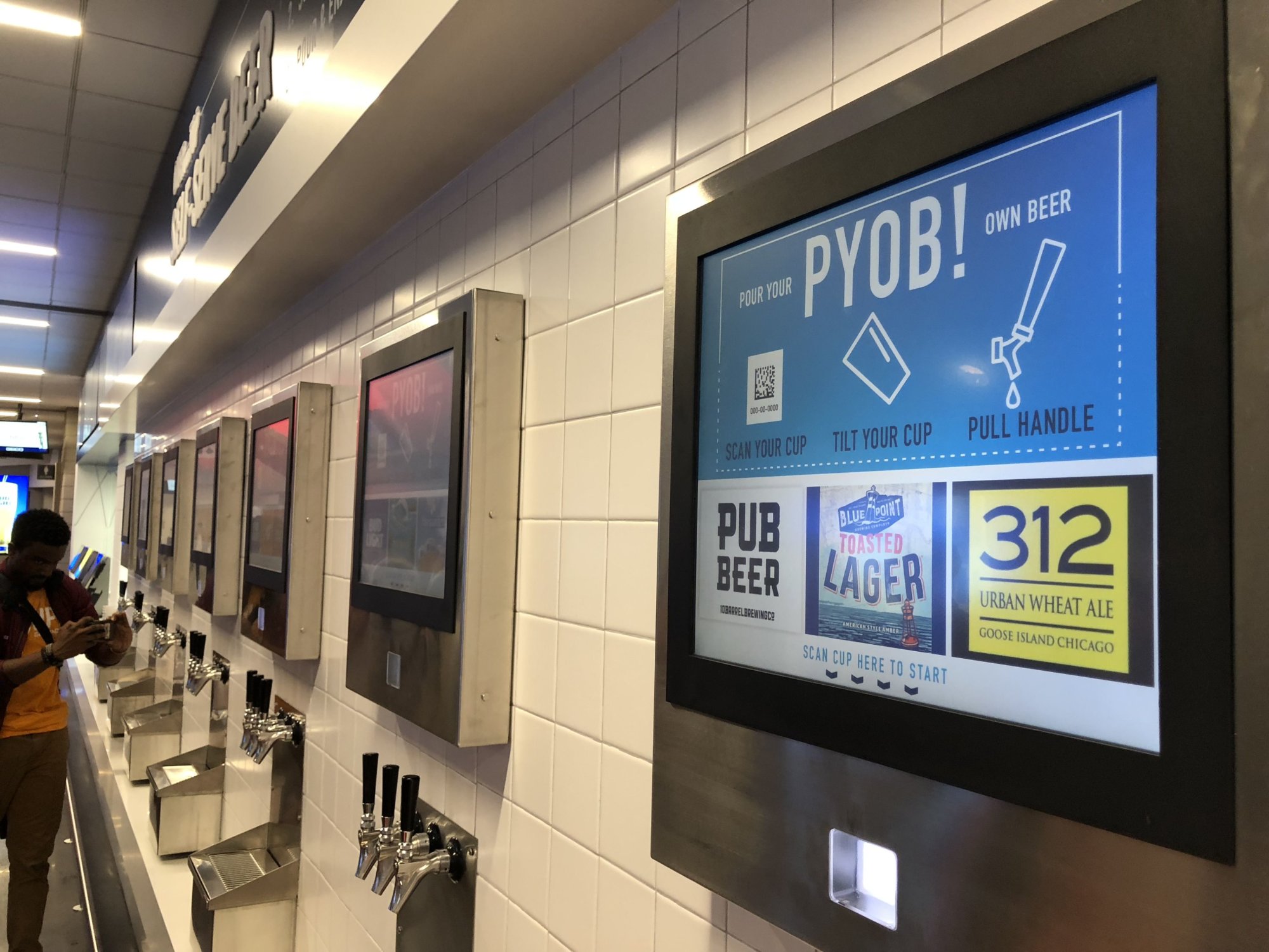 The beer wall near section 417 offers 17 different varieties of self-serve beers. (WTOP/Kristi King)