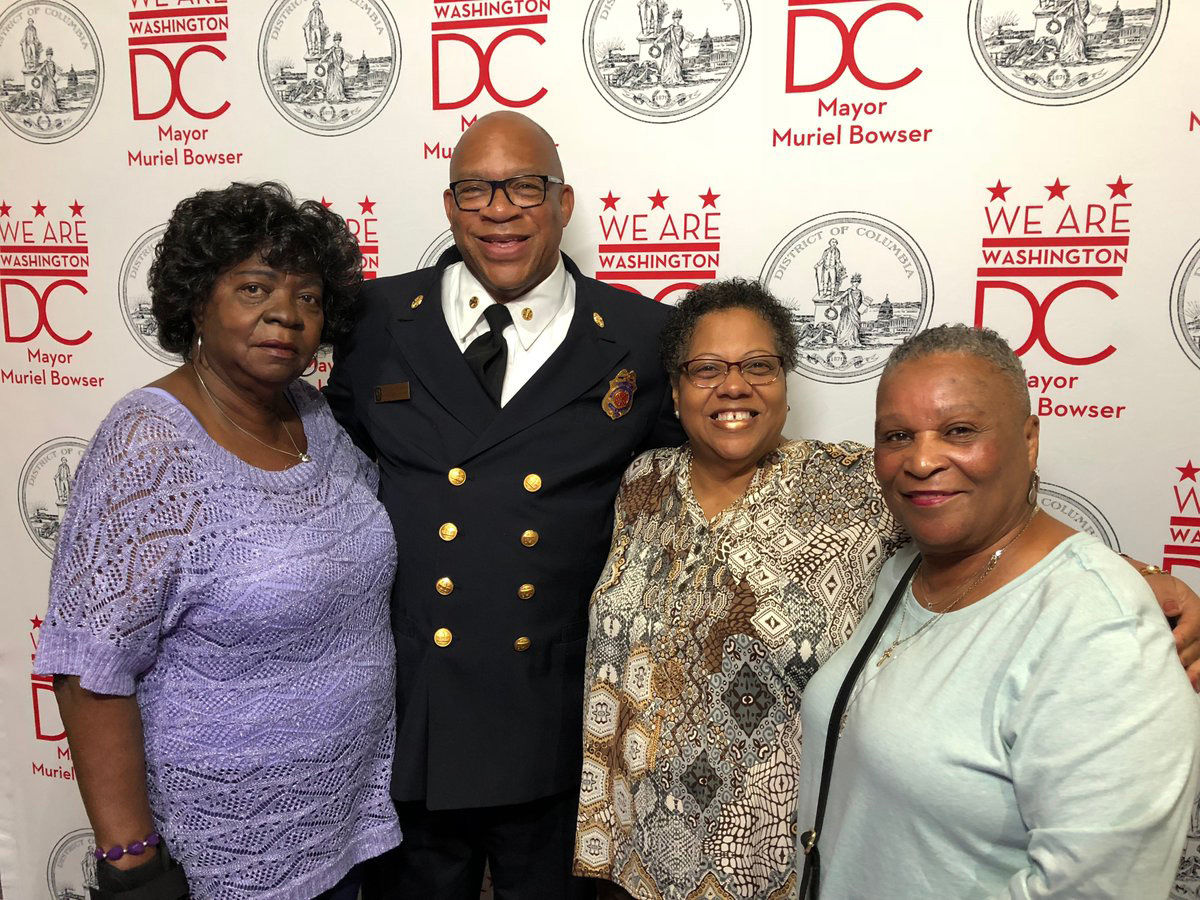 Fire Chief Gregory Dean at the luncheon, with Hattie McLaurin, Darlene Hodges and Claudia Walker. (WTOP/Kristi King)