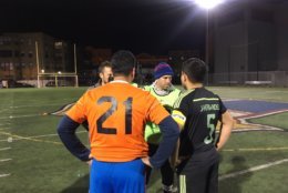 Team captains from Oyamel and Jaleo D.C. meet before the opening kick of this year's Copa final. (WTOP/Noah Frank)
