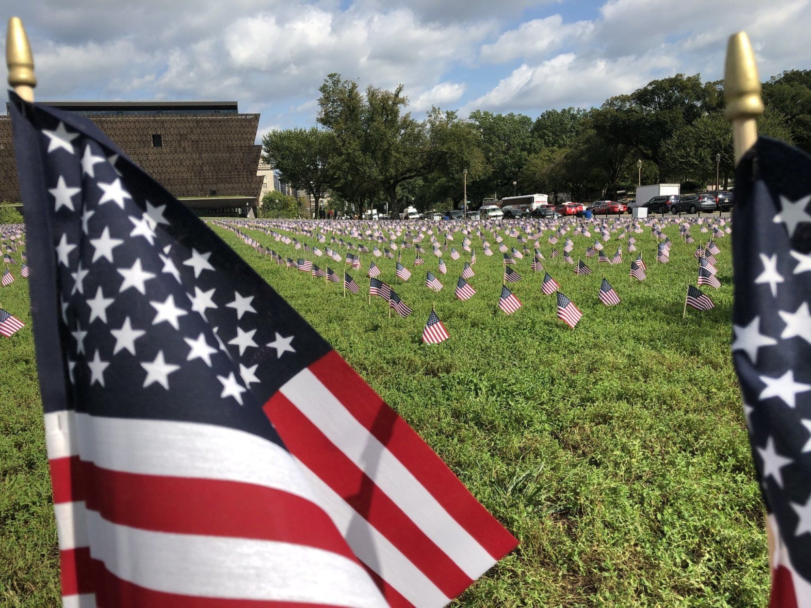 In all, 5,520 postcard-size flags were planted on a patch of grass between the Washington Monument and 15th Street to represent veteran suicides occurring in 2018 through Wednesday. (WTOP/Kristi King)