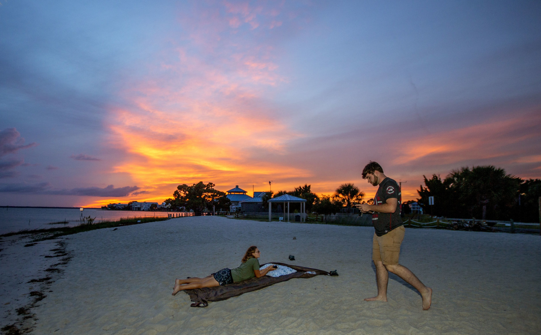 CRAWFORDVILLE, FL - OCTOBER 09: Tad West and Caitlyn Martin hang out on an empty Shell Point Beach as the sun set prior to the arrival of Hurricane Michael on October 9, 2018 in Crawfordville, Florida. Shell Point Beach is 30 miles south of Tallahassee. Florida. Hurricane Michael, which strengthened to a Category 3 storm today with sustained winds of 120 mph, is expected to make landfall in the Florida Panhandle by Wednesday. (Photo by Mark Wallheiser/Getty Images)