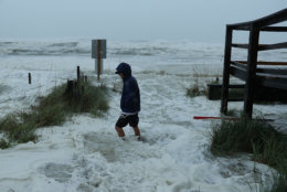 PANAMA CITY BEACH, FL - OCTOBER 10:  Cameron Sadowski walks along where waves are crashing onto the beach as the outer bands of  hurricane Michael arrive on October 10, 2018 in Panama City Beach, Florida. The hurricane is forecast to hit the Florida Panhandle at a possible category 4 storm.  (Photo by Joe Raedle/Getty Images)