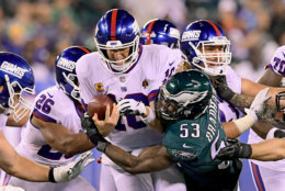 EAST RUTHERFORD, NJ - OCTOBER 11:  Eli Manning #10 of the New York Giants is sacked by Nigel Bradham #53 of the Philadelphia Eagles during the fourth quarter at MetLife Stadium on October 11, 2018 in East Rutherford, New Jersey.  The Eagles defeated the Giants 34-13.  (Photo by Steven Ryan/Getty Images)