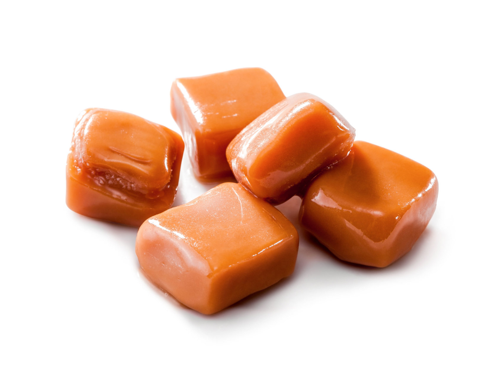slightly melted toffee caramel candy close-up isolated (with clipping path) on white background