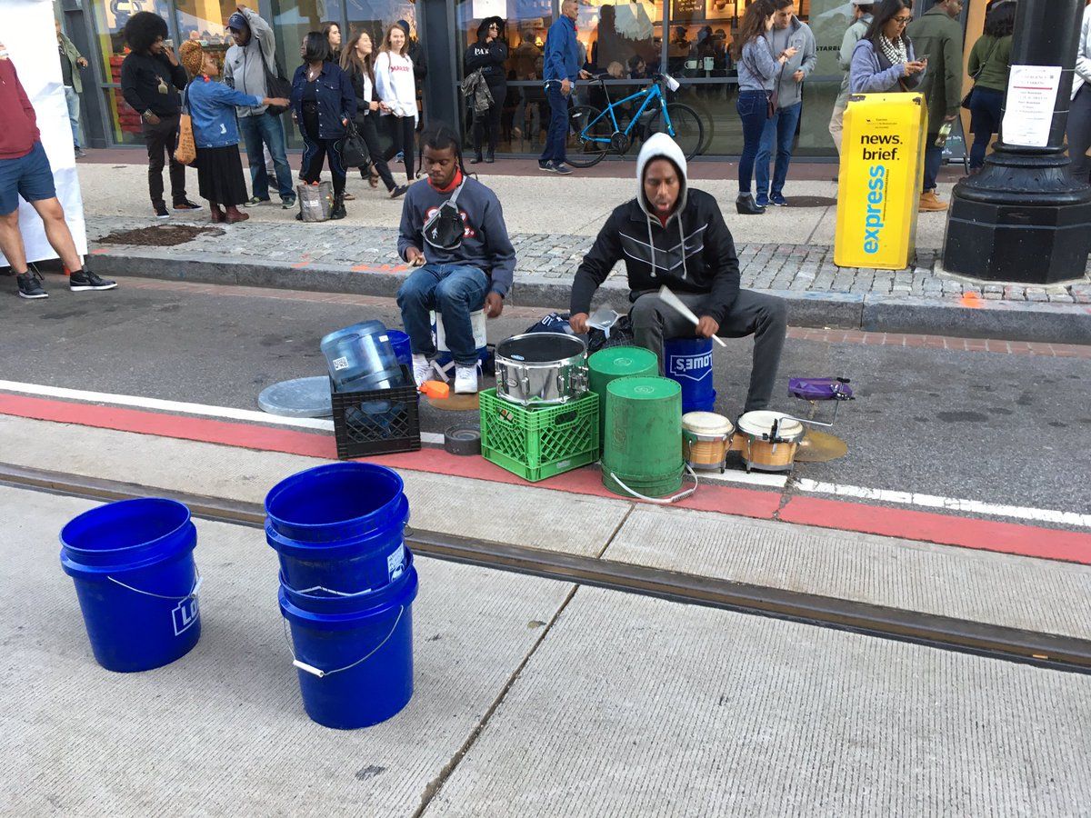 Drummers perform on what would normally be a lane for cars and the H Street streetcars. (WTOP/Liz Anderson)