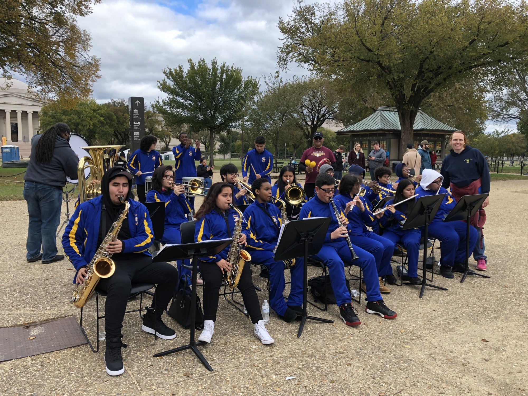 Local marching band gives back by playing to inspire marathon runners