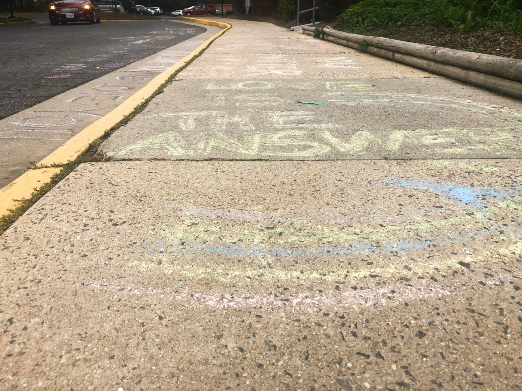 Messages of support were left on the sidewalk in front of the Jewish Community Center of Northern Virginia, in Annandale, two days after swastikas were spray-painted on the building. (WTOP/Melissa Howell)