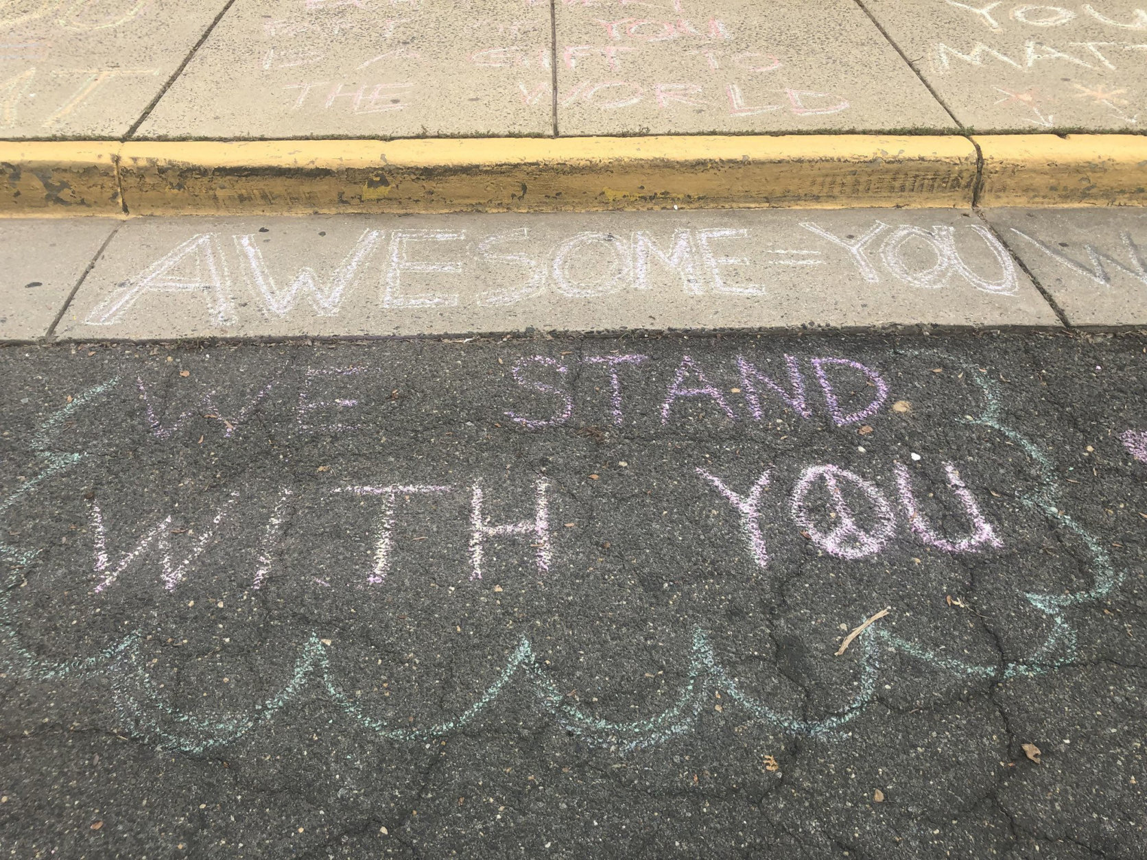 Messages of support were left on the sidewalk in front of the Jewish Community Center of Northern Virginia, in Annandale, two days after swastikas were spray-painted on the building. (WTOP/Melissa Howell)