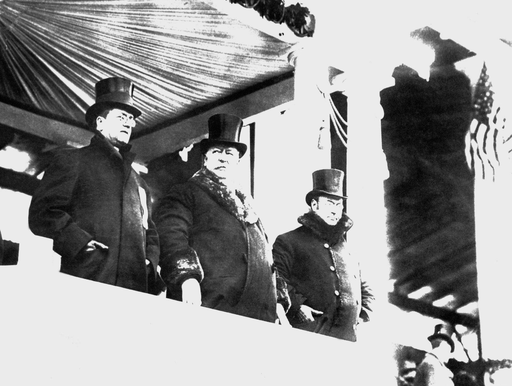 William Howard Taft, center, wore big fur-lined overcoat when he reviewed parade after his inauguration as president, on March 4, 1909 in Washington.  At right is James S. Sherman, vice president of the United States, and at left Edward Hallwagon, chief of the Inaugural Committee.    A whirling blizzard, featured by flashes of lighting, as well as rain, snow and a cutting wind, made it one of the roughest of all inauguration days. (AP Photo)