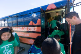 Students from the Manassas, Virginia's Loch Lomond Elementary School robotics team were the first ones to board the Lockheed Martin Mars Experience Bus after a morning ceremony at the Steven F. Udvar-Hazy Center in Chantilly, Virginia, Oct. 19, 2018. Lockheed Martin donated the bus, fitted with high-definition monitors on the windows, which provide visitors an opportunity to experience the Martian surface. (Air and Space Museum/Daniel Soñé)