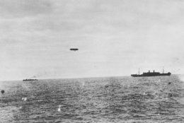 U.S. Army transport Mallory, escorted by a U.S. destroyer and a French dirigible as it approached the harbor at Brest, France Oct. 26, 1918. (AP Photo)