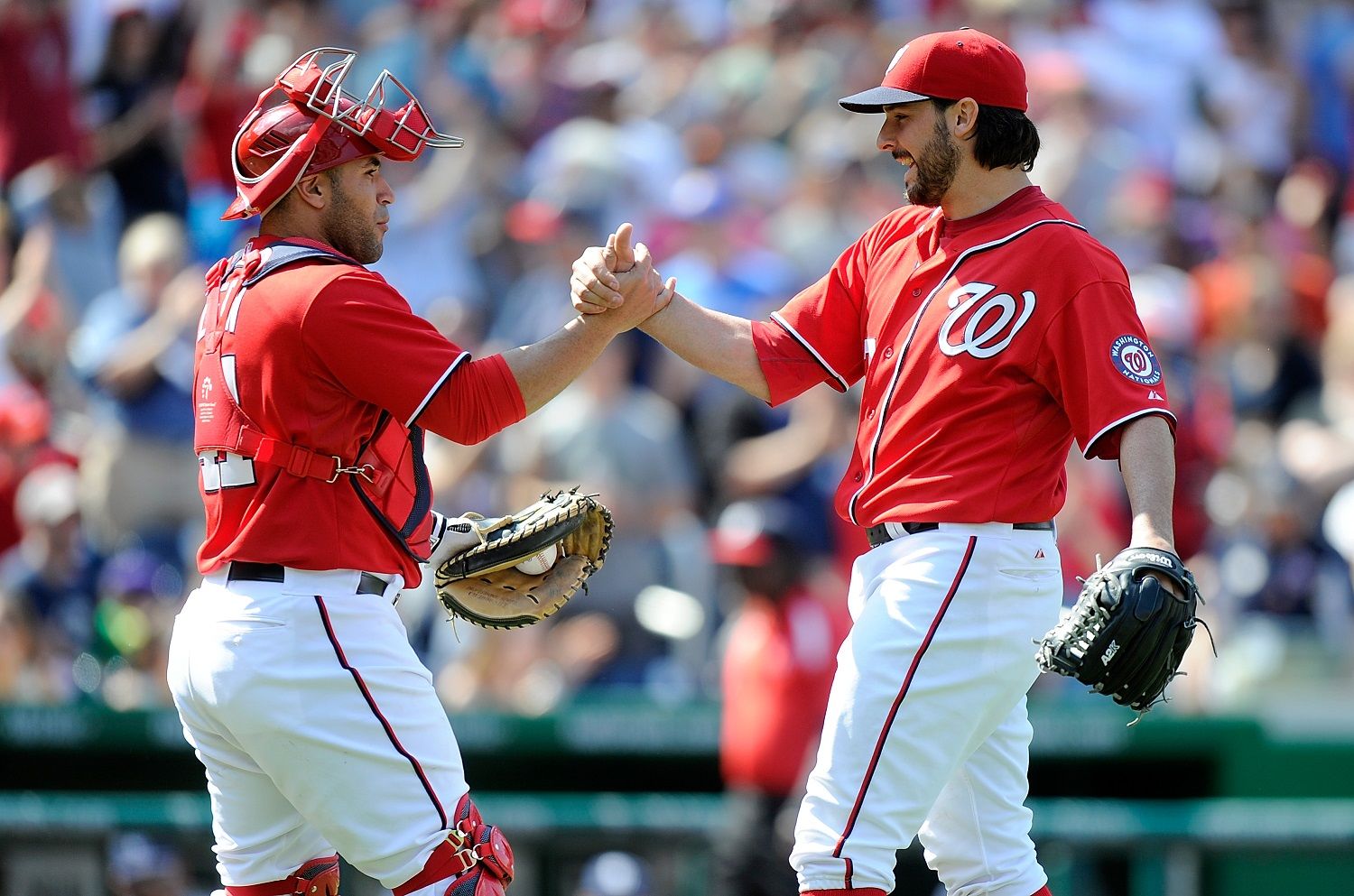 WASHINGTON, DC - APRIL 26:  Tanner Roark #57 of the Washington Nationals celebrates with Sandy Leon #41 after pitching a complete game shutout against the San Diego Padres at Nationals Park on April 26, 2014 in Washington, DC. Washington won the game 4-0.  (Photo by Greg Fiume/Getty Images)