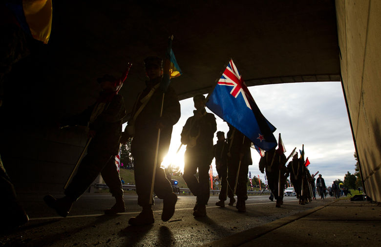 Marines walk with flags near the start of the marathon. (AP Photo/Jose Luis Magana)