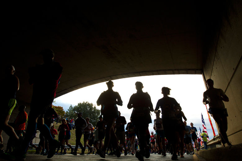 Runners pass under a tunnel near the start of the marathon. (AP Photo/Jose Luis Magana)