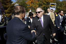 Maryland Gov. Larry Hogan greets supporters outside a polling place after voting early, Tuesday, Oct. 30, 2018, in Annapolis, Md. Hogan is running for re-election against Democratic candidate Ben Jealous. (AP Photo/Patrick Semansky)
