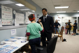 Maryland Democratic gubernatorial candidate Ben Jealous, center right, fist-bumps volunteer Evie Frankl during a visit to a Montgomery County coordinated campaign office, Monday, Nov. 5, 2018, in Silver Spring, Md. Jealous is running against incumbent Gov. Larry Hogan. (AP Photo/Patrick Semansky)