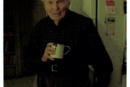 Frank Woodruff Buckles holds the chipped metal cup he used during his 39-month internment in Japanese prison camps. (Veterans History Project Collection, American Folklife Center, Library of Congress)