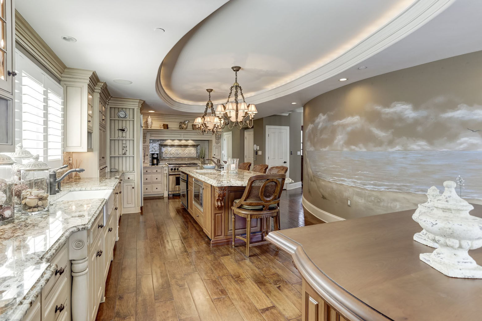The kitchen includes sinks, two dishwashers and two islands, and a hand-painted mural of the sea. (Courtesy HomeVisit)