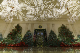 Grand Foyer and Cross Hall leading into the Blue Room and the official White House Christmas tree are seen during the 2018 Christmas Press Preview at the White House in Washington, Monday, Nov. 26, 2018. Christmas has arrived at the White House. First lady Melania Trump unveiled the 2018 White House holiday decor on Monday. She designed the decor, which features a theme of "American Treasures." (AP Photo/Carolyn Kaster)
