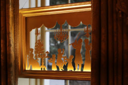 WASHINGTON, DC - NOVEMBER 26: A window silhouette of U.S. President Thomas Jefferson playing the violin for his family in 1805 hangs in a window of the Vermeil Room which is decorated for the holidays at the White House November 26, 2018 in Washington, DC. The 2018 theme of the White House holiday decorations is 'American Treasures,' and features patriotic displays highlighting the country's 'unique heritage.' The White House expects to host 100 open houses and more than 30,000 guests who will tour the topiary trees, architectural models of major U.S. cities, the Gold Star family tree and national monuments in gingerbread. (Photo by Chip Somodevilla/Getty Images)