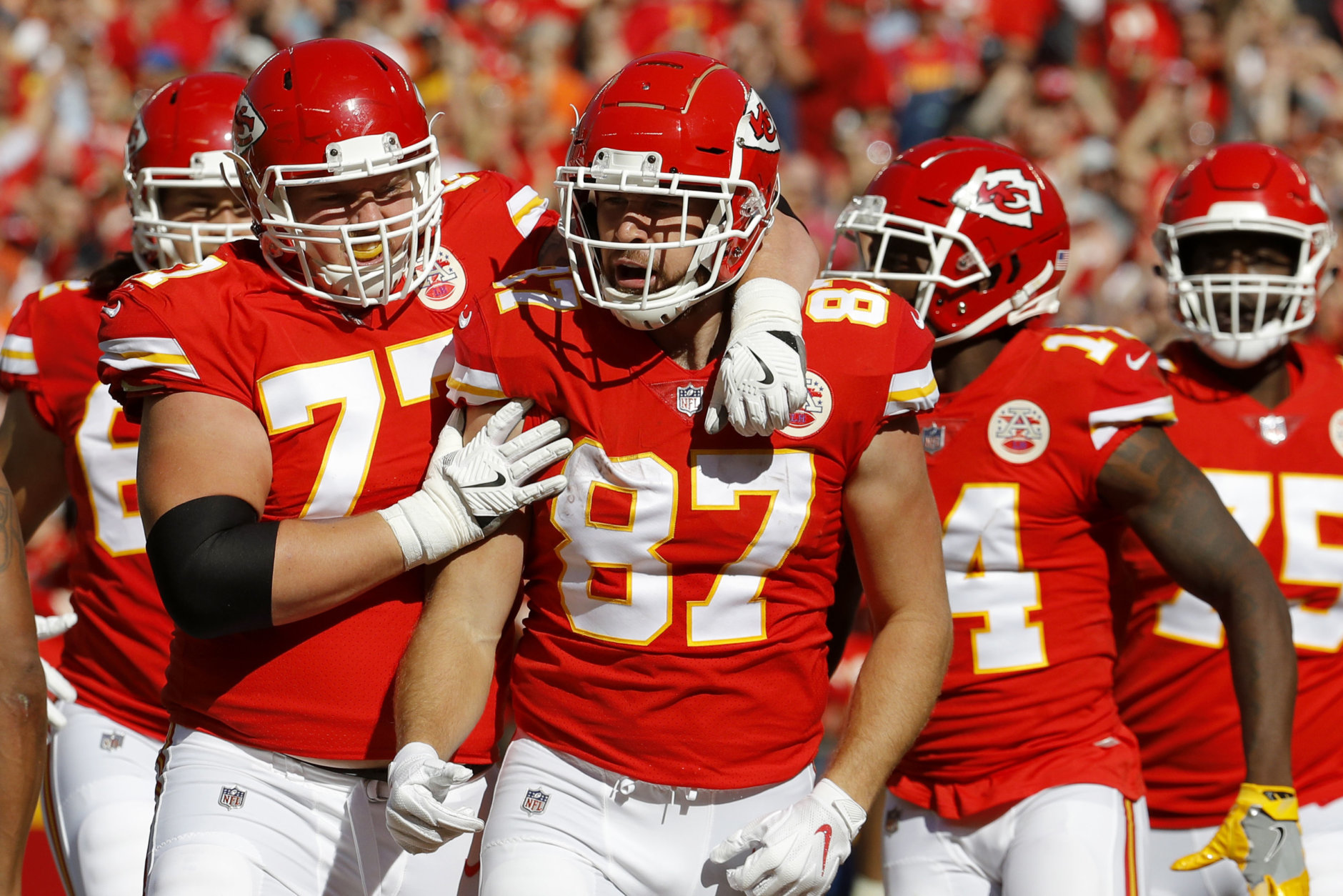 Kansas City Chiefs tight end Travis Kelce (87) celebrates a touchdown in front of offensive lineman Andrew Wylie (77) and wide receiver Sammy Watkins (14) during the first half of an NFL football game against the Denver Broncos in Kansas City, Mo., Sunday, Oct. 28, 2018. (AP Photo/Charlie Riedel)