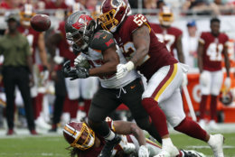 Tampa Bay Buccaneers running back Jacquizz Rodgers (32) fumbles as he is hit by Washington Redskins linebacker Ryan Anderson (52) during the second half of an NFL football game Sunday, Nov. 11, 2018, in Tampa, Fla. (AP Photo/Mark LoMoglio)