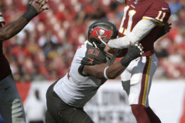 Washington Redskins quarterback Alex Smith (11) throws a pass while under pressure from Tampa Bay Buccaneers defensive tackle Gerald McCoy (93) during the first half of an NFL football game Sunday, Nov. 11, 2018, in Tampa, Fla. (AP Photo/Phelan M. Ebenhack)
