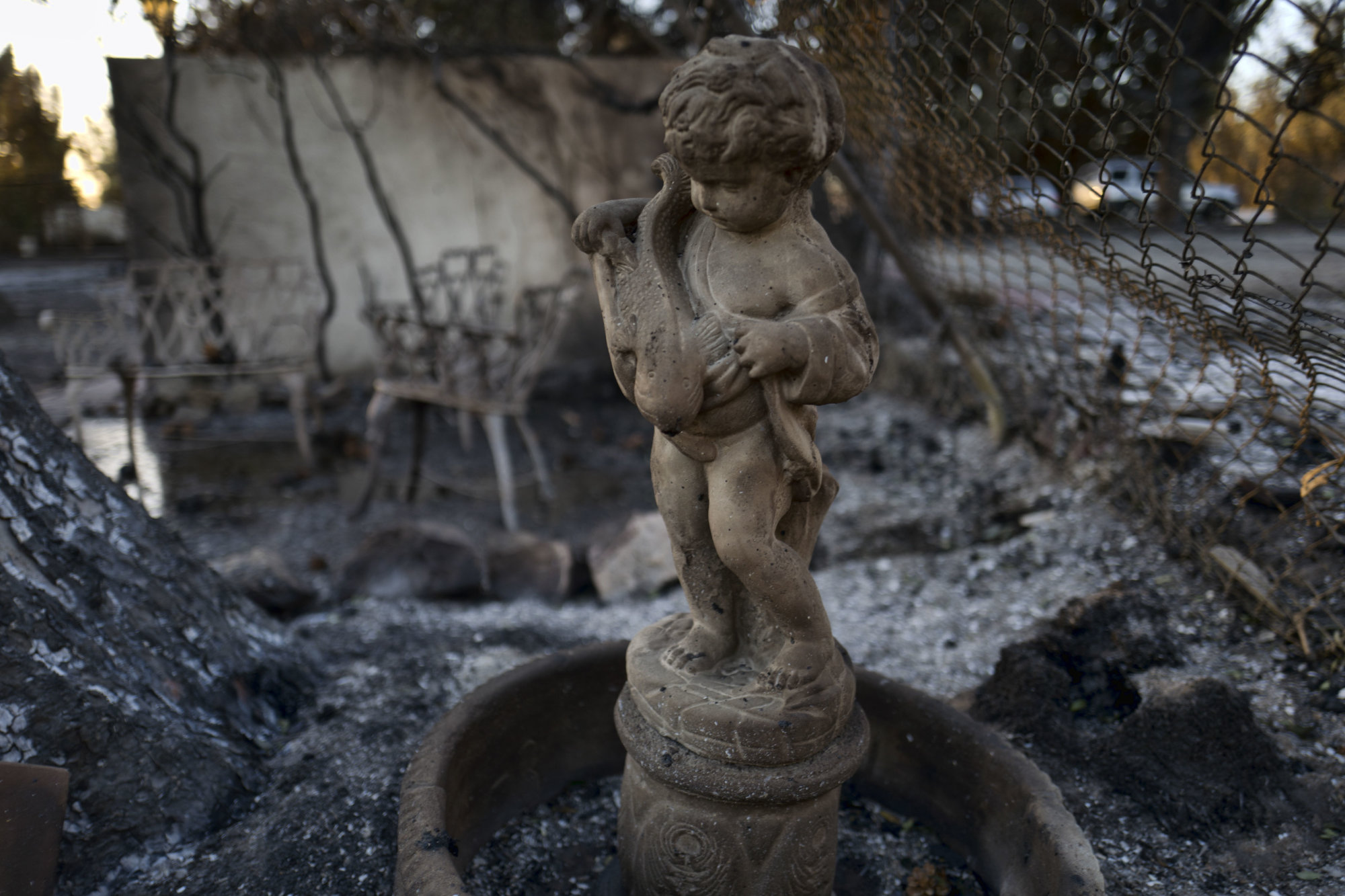 The remains of a burned fountain stands among a destroyed home in the Point Dome neighborhood in Malibu, Calif., on Monday, Nov. 12, 2018. (AP Photo/Richard Vogel)