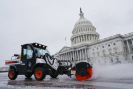 Worker clears the first snow of the season in front of the Capitol in Washington, Thursday, Nov. 15, 2018. (AP Photo/Pablo Martinez Monsivais)