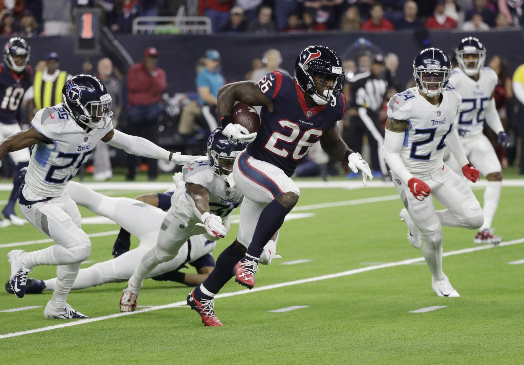 Houston Texans running back Lamar Miller (26) breaks away from Tennessee Titans defenders for a 97-yard touchdown run during the first half of an NFL football game, Monday, Nov. 26, 2018, in Houston. (AP Photo/David J. Phillip)