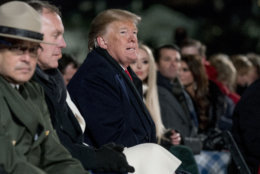 President Donald Trump attends the National Christmas Tree lighting ceremony at the Ellipse near the White House in Washington, Wednesday, Nov. 28, 2018. Also pictured is Interior Secretary Ryan Zinke, second from left. (AP Photo/Andrew Harnik)