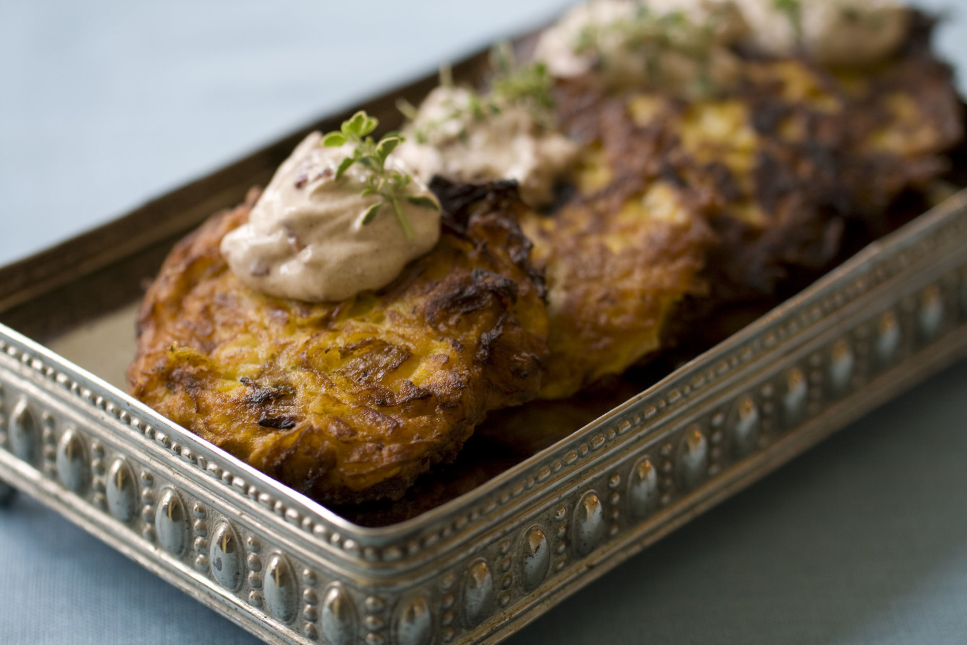 This Oct. 7, 2013 photo shows pumpkin latkes with spiced cranberry sour cream in Concord, N.H. Though potatoes have their own symbolism in the Jewish holiday of Hanukkah, it is the oil used in the frying that is particularly significant; it symbolizes the long-lasting oil burned in the temple lamps in the story of Hanukkah. And that is why there are so many latke variations, including sweet potato, onion and carrot. (AP Photo/Matthew Mead)