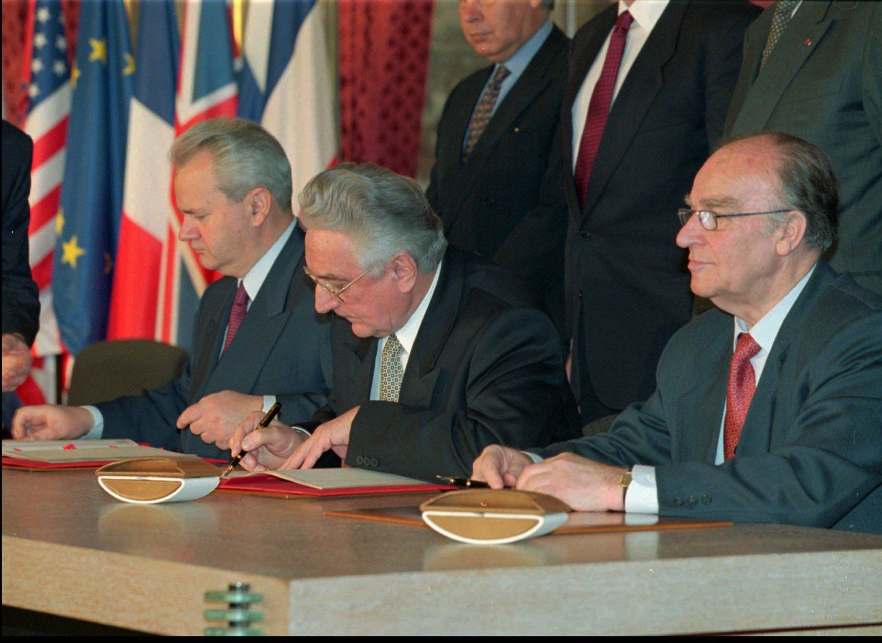 Balkan leaders from the left: Slobodan Milosevic, Serbia, Franjo Tudjman, Croatia, and Alija Izetbegovic, Bosnia, during the signing of the treaty to forge an end to Europe's most devastating conflict since WWII, in the Elysee Palace in Paris Thursday December 14, 1995.(AP PHOTO/Jerome Delay/pool)
