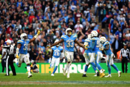LONDON, ENGLAND - OCTOBER 21: Derwin James (33) of the Los Angeles Chargers celebrates with team mates after the final turnover during the Tennessee Titans against the Los Angeles Chargers at Wembley Stadium on October 21, 2018 in London, England. (Photo by Justin Setterfield/Getty Images)