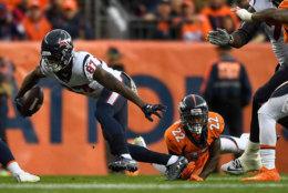 DENVER, CO - NOVEMBER 4:  Wide receiver Demaryius Thomas #87 of the Houston Texans breaks away from a tackle attempt by defensive back Tramaine Brock #22 of the Denver Broncos in the first quarter of a game at Broncos Stadium at Mile High on November 4, 2018 in Denver, Colorado. (Photo by Dustin Bradford/Getty Images)