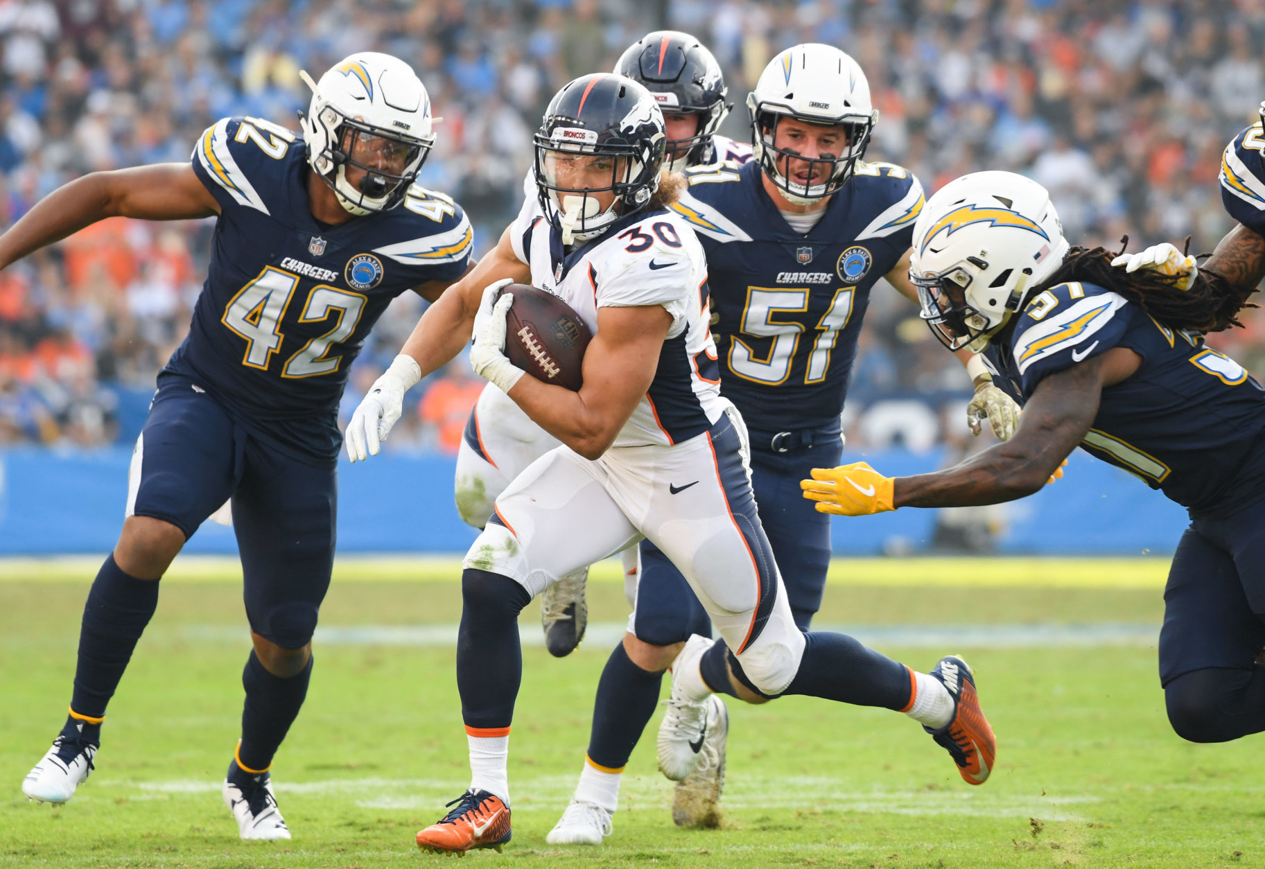CARSON, CA - NOVEMBER 18: Running back Phillip Lindsay #30 of the Denver Broncos runs as he's chased by strong safety Jahleel Addae #37 of the Los Angeles Chargers in the third quarter at StubHub Center on November 18, 2018 in Carson, California. (Photo by Harry How/Getty Images)