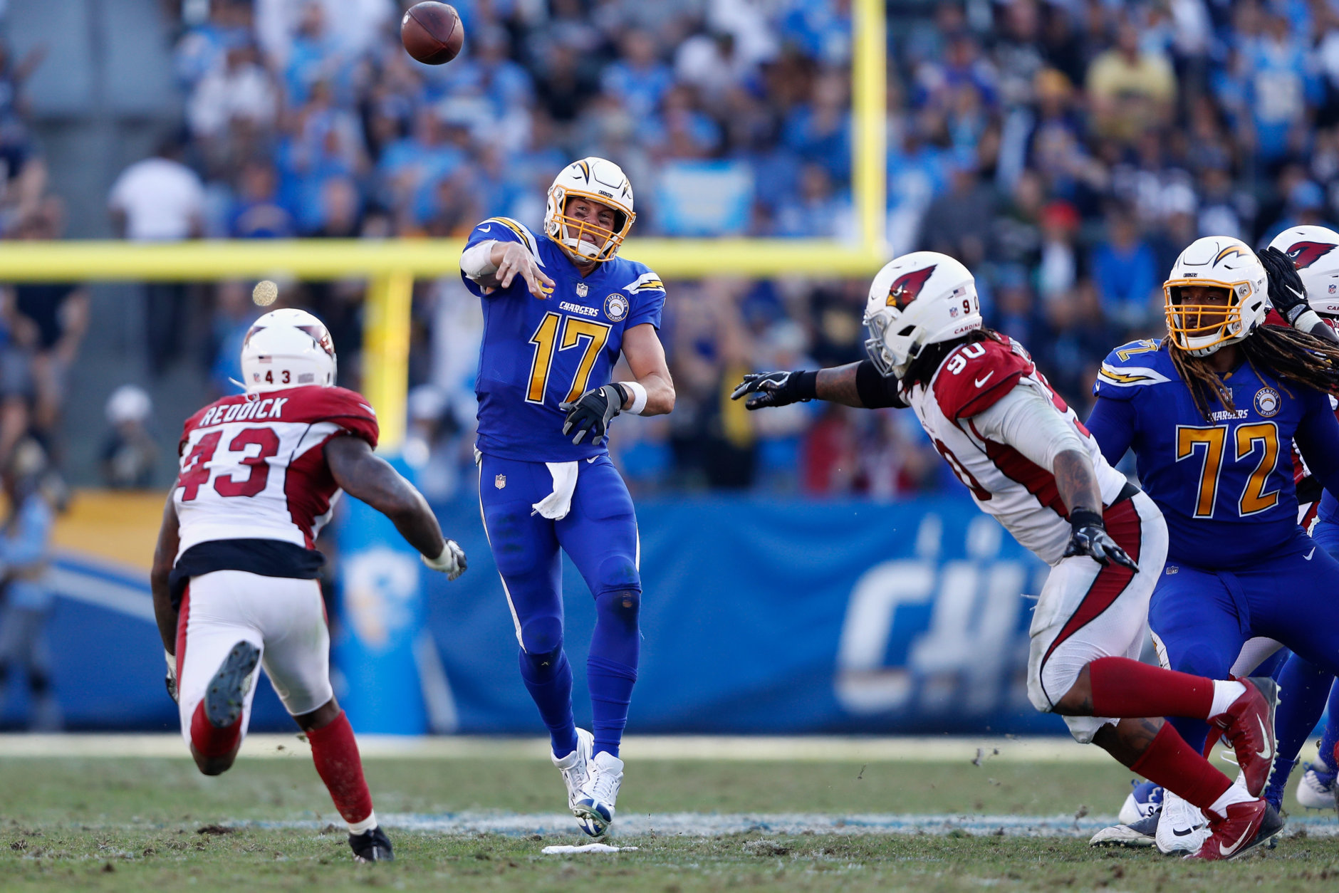 CARSON, CA - NOVEMBER 25:  Philip Rivers #17 of the Los Angeles Chargers passes the ball under pressure from Robert Nkemdiche #90 and Haason Reddick #43 of the Arizona Cardinals during the second half of a game at StubHub Center on November 25, 2018 in Carson, California.  (Photo by Sean M. Haffey/Getty Images)