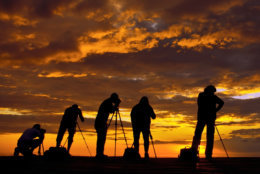 photographers in backlight at sunrise
