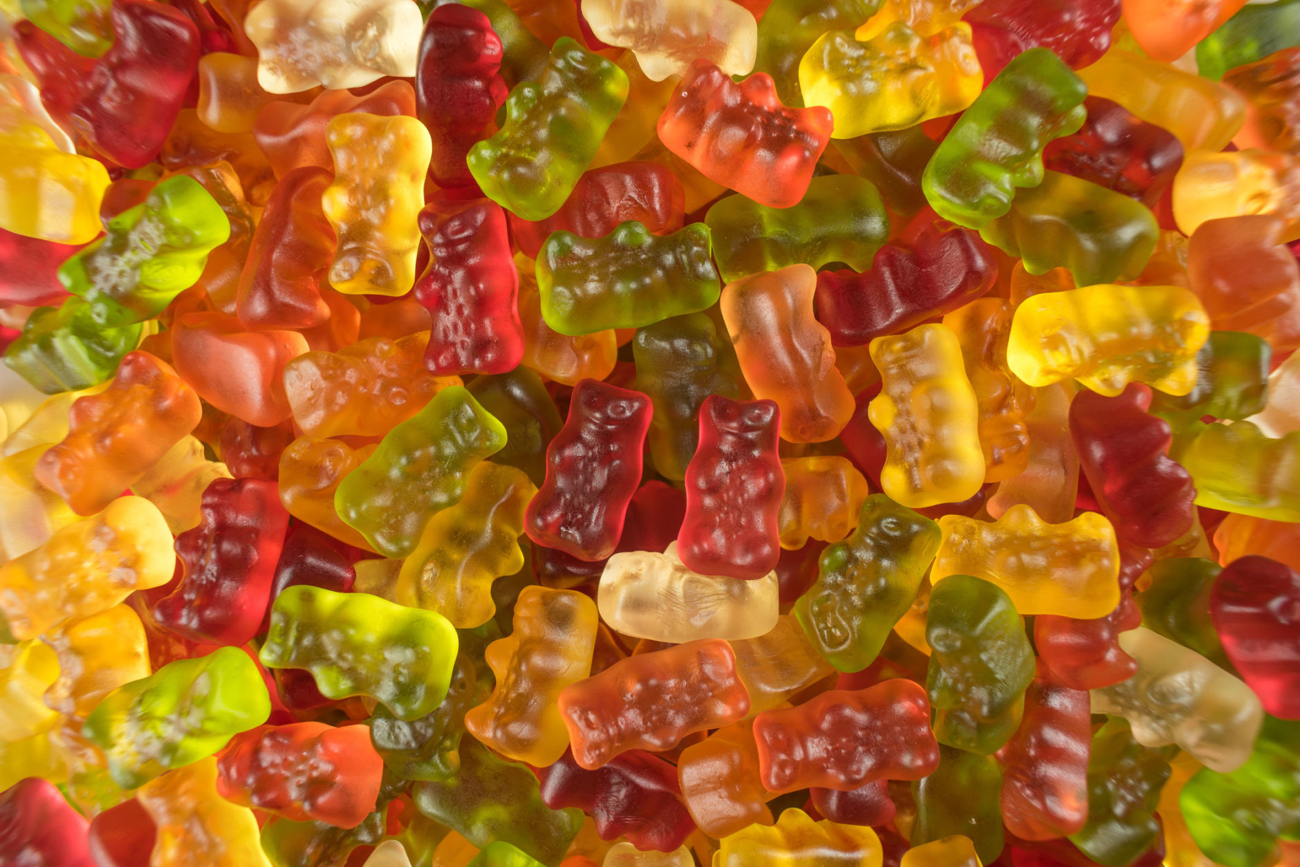 Heap of colorful jelly babies / gummy bear sweets. Potential use as a background.