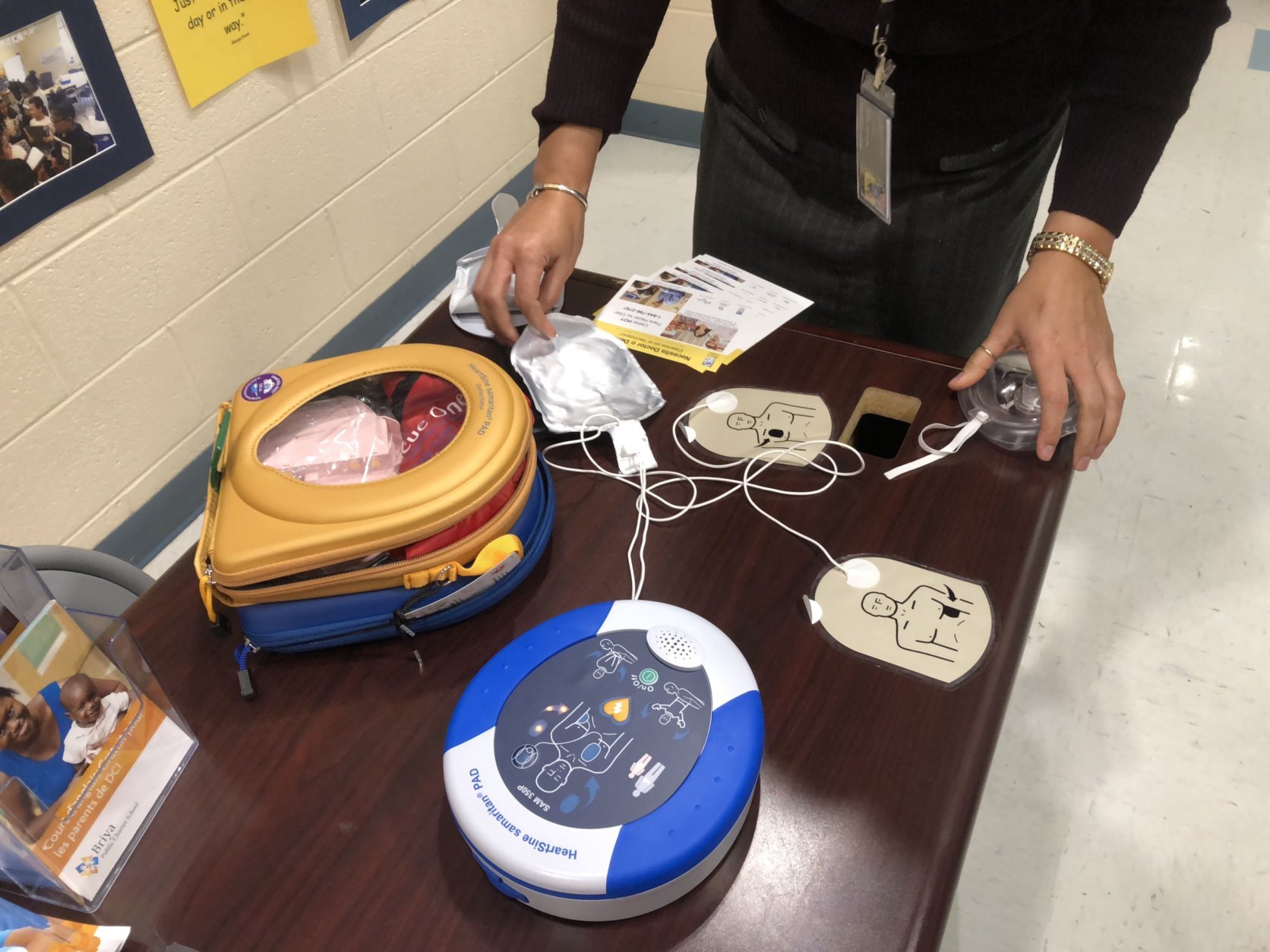 Allie Bobak said she ran to the lobby where the school had a prominently placed automated external defibrillator, and ran back to the polling site with it to help the man who collapsed. (WTOP/Mike Murillo)