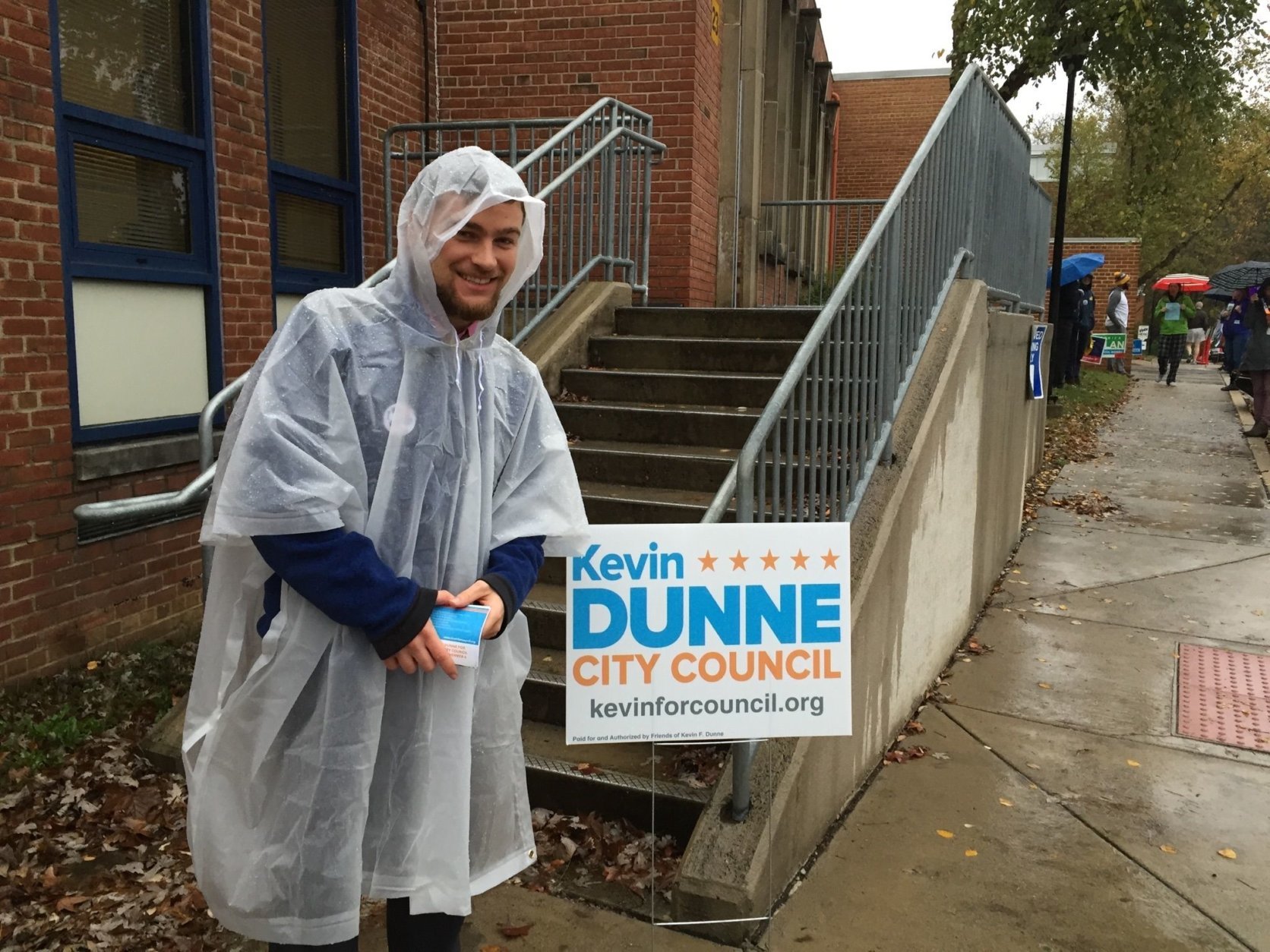 Kevin Dunne, candidate for Alexandria City Council, greets voters in the rain at the MacArthur Precinct in Alexandria, Virginia, on Nov. 6, 2018. (Courtesy Linda App)