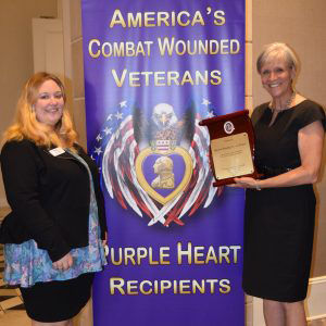 April Weiner of the National Court Reporters Association and Foundation and Nancy Hopp, former Foundation Chair accepted a plaque on behalf of NCRF from the Military Order of the Purple Heart. (Courtesy NCRA)