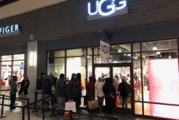 Shoppers stood in line in the cold to buy furry boots at the Ugg store. (WTOP/Neal Augenstein)