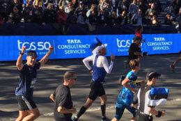 U.S. Secret Service Agents Mason Brayman and Bill Uher cross the finish line of the New York City Marathon on Sunday along with the Estonian president. (Courtesy U.S. Secret Service)
