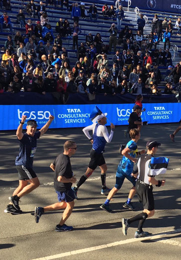 U.S. Secret Service Agents Mason Brayman and Bill Uher cross the finish line of the New York City Marathon on Sunday along with the Estonian president. (Courtesy U.S. Secret Service)